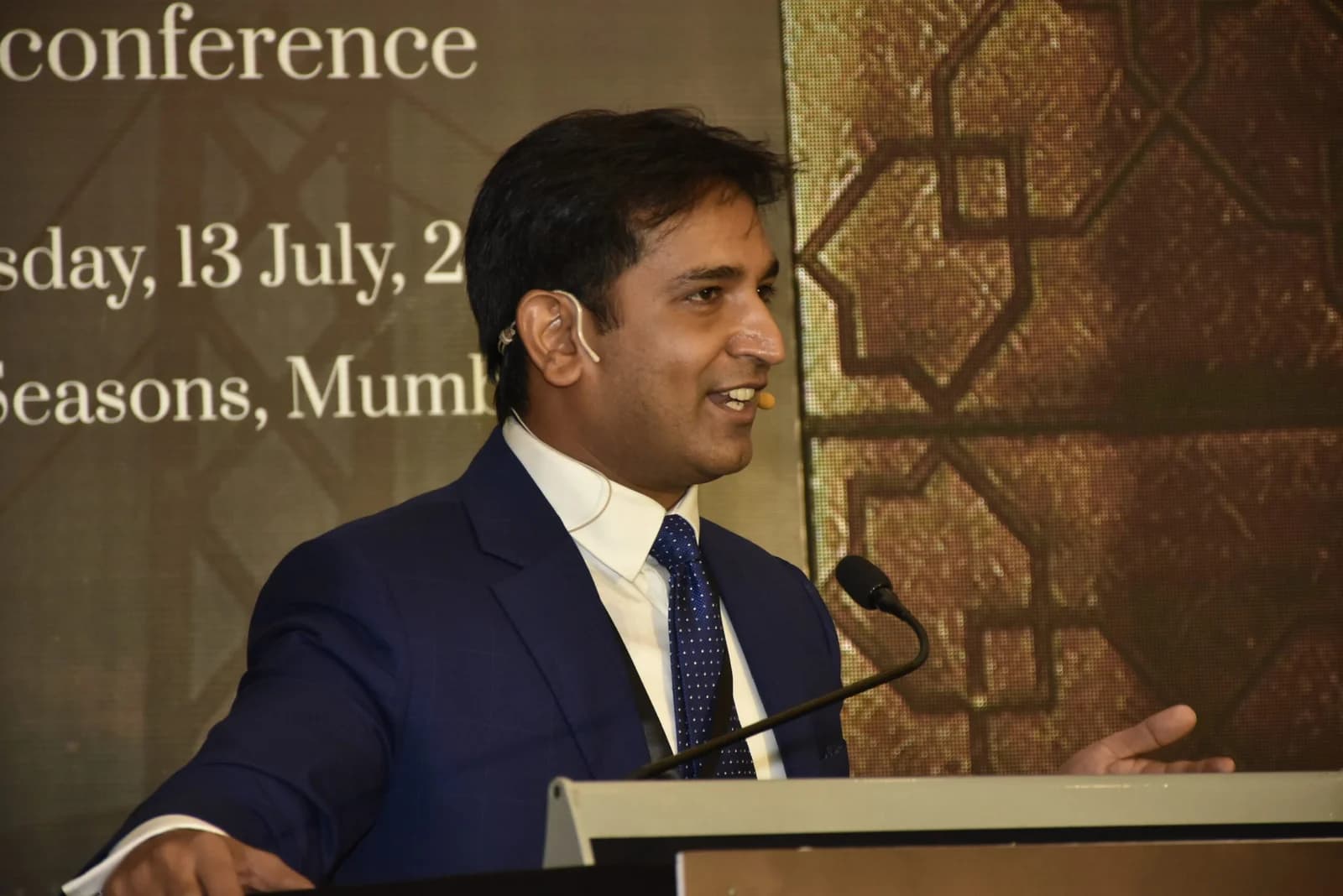 Conference speaker at podium 24