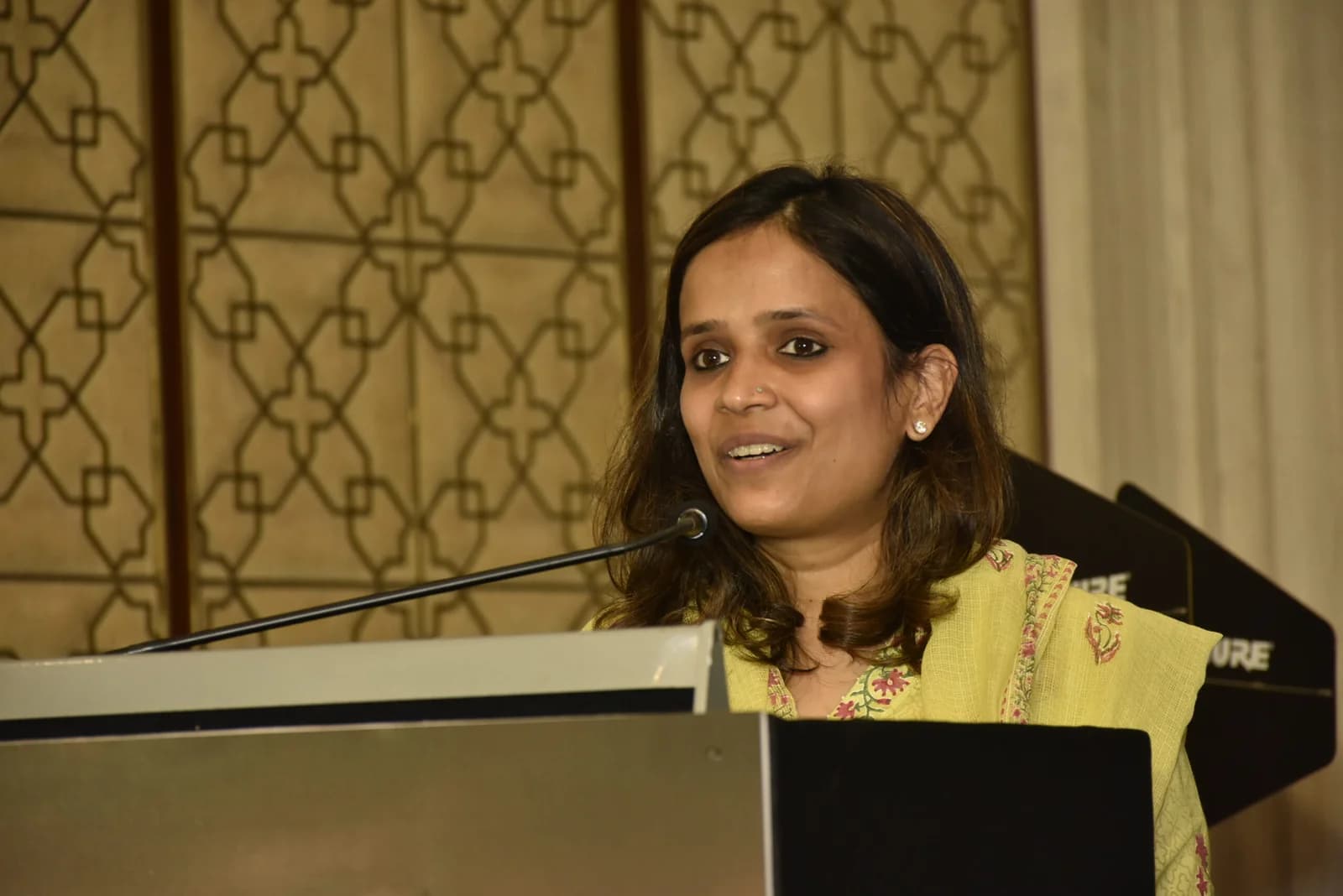 Conference speaker at podium 25